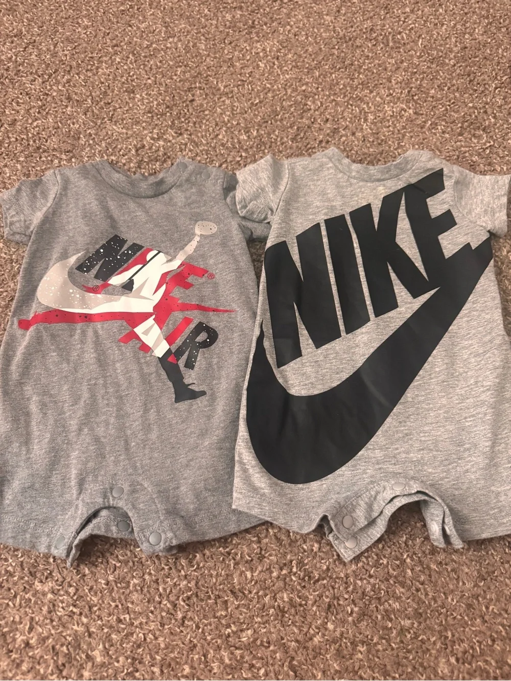 Two Nike Onesies